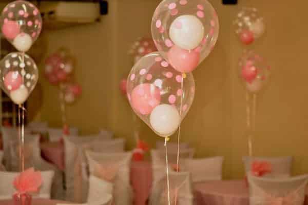 Centro de mesa feito com balões de gás hélio um dentro do outro para decoração chá de bebê